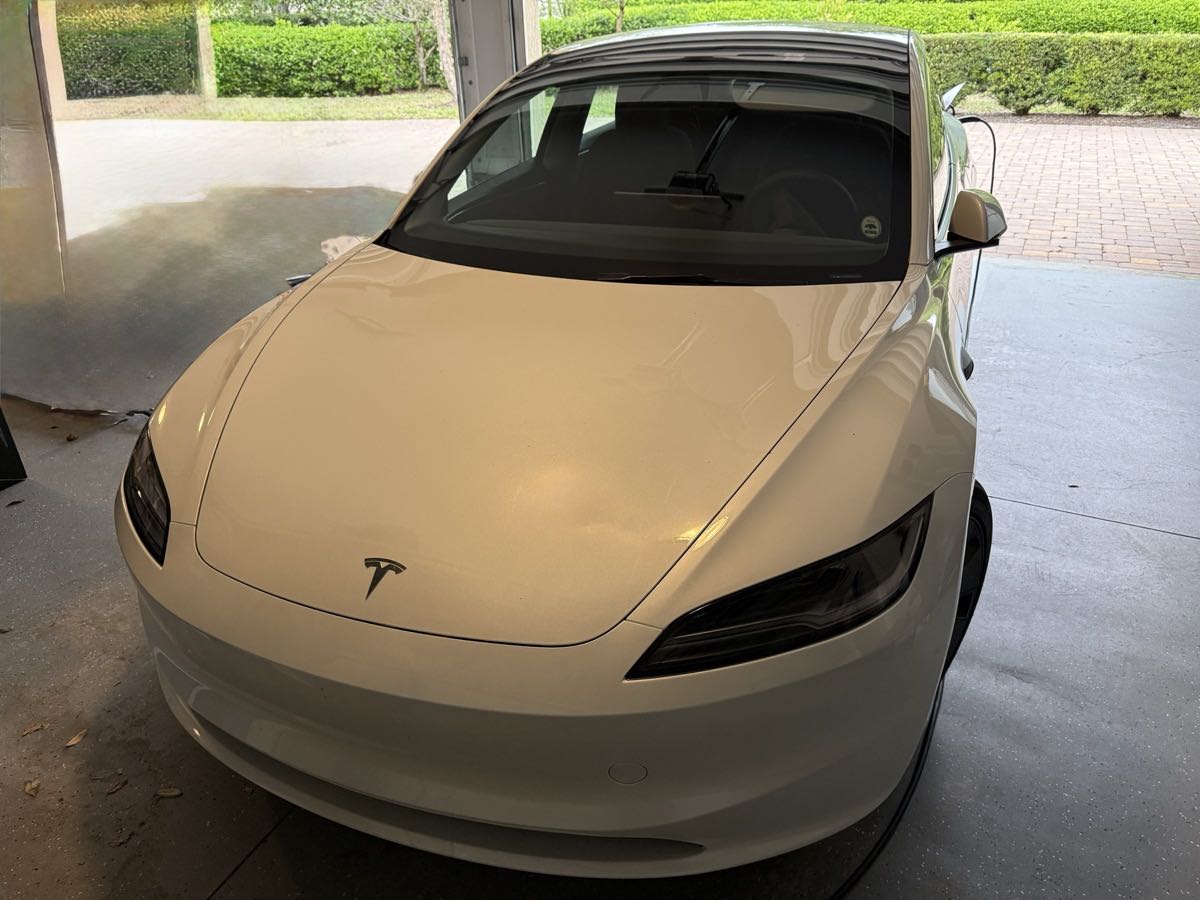 White Tesla Model 3 at Jacksonville home with Pure Power charger installation