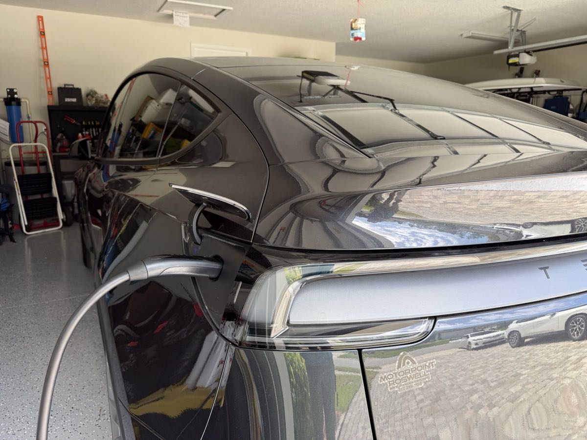 Tesla Model Y charging port closeup showing Level 2 connection